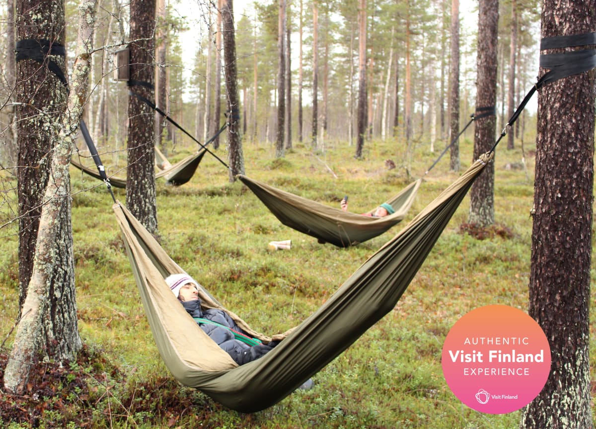 A group of friends relaxing in the hammocks in an autumn forest